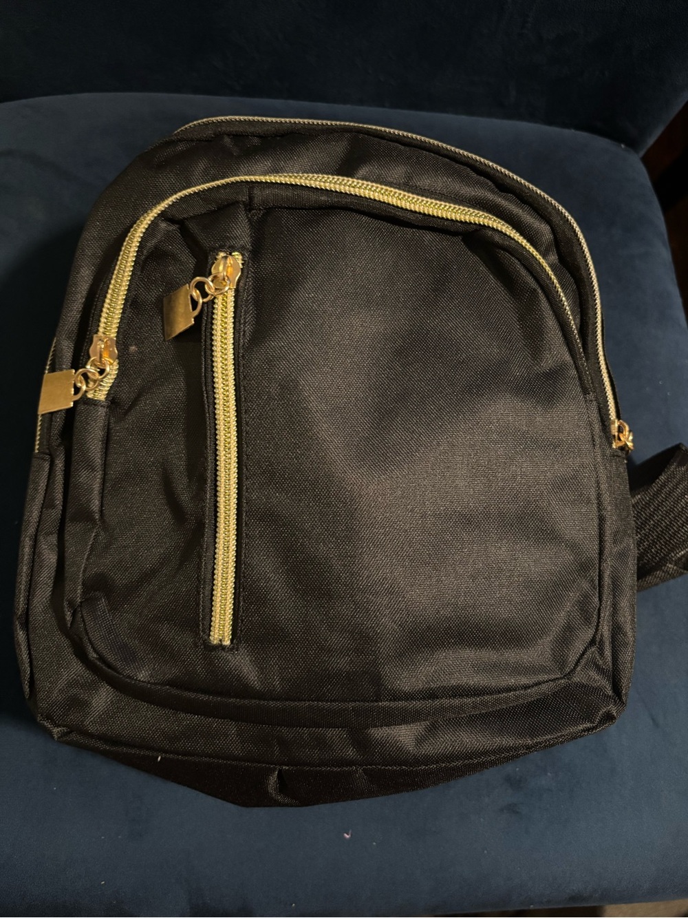 Men’s Black Backpack with Gold Zipper Accents